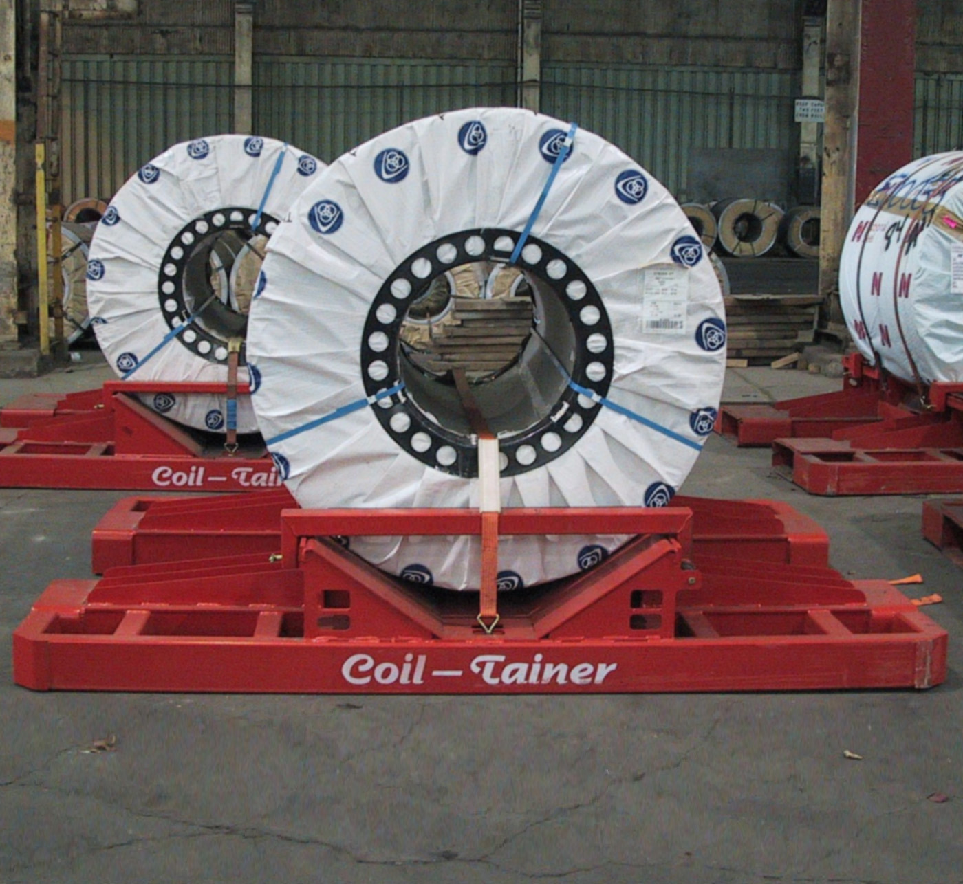 A steel coil secured on the patented Coil-Tainer steel pallet inside a shipping container